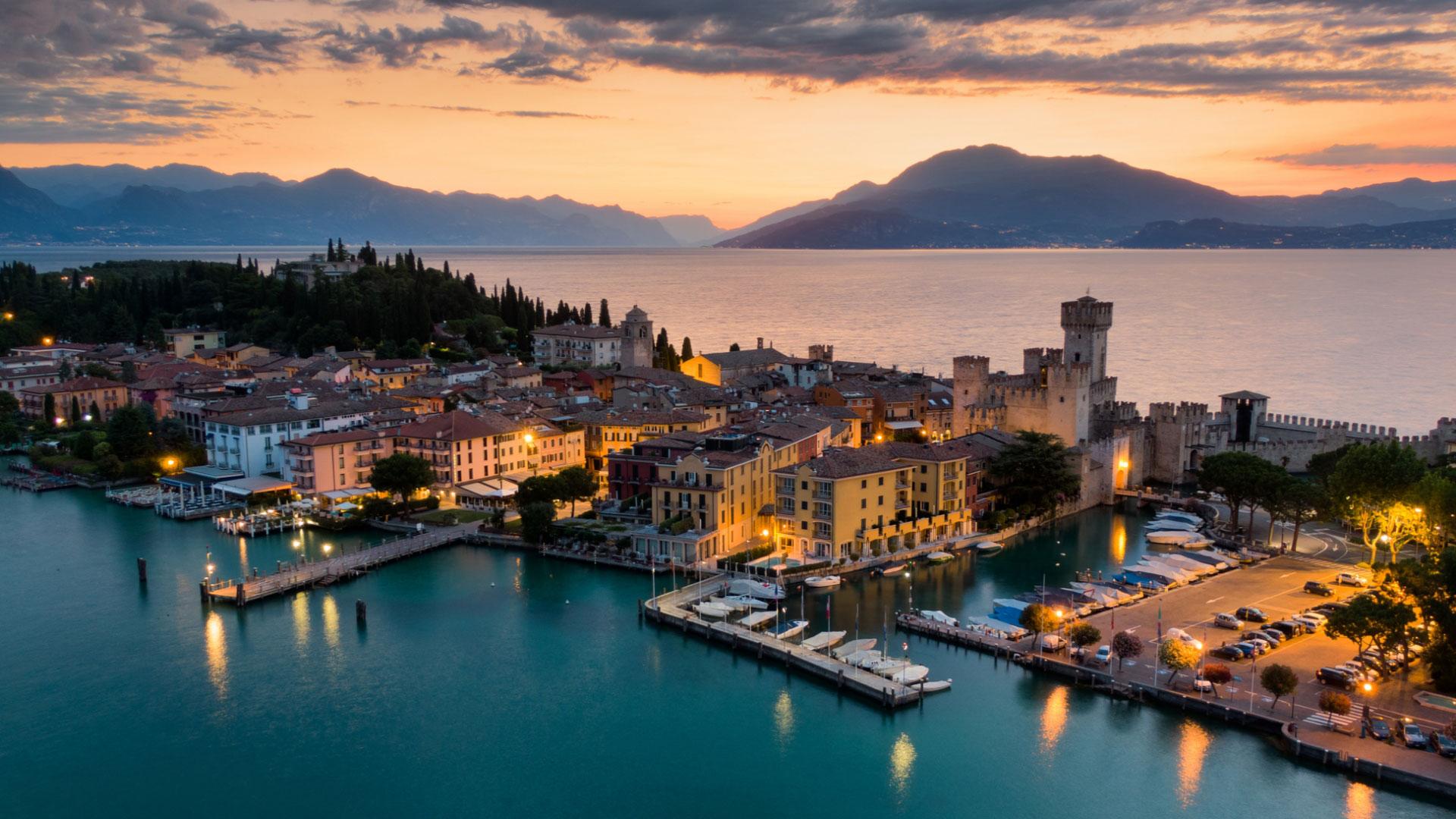 Panoramic view of Sirmione at sunset, with the castle and Lake Garda.