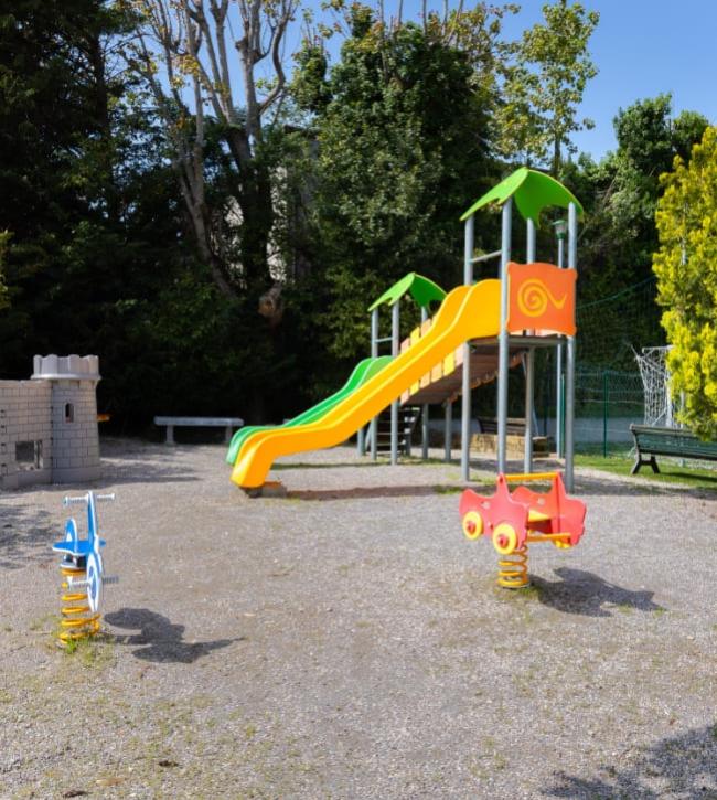 Playground with colorful slide and spring riders.